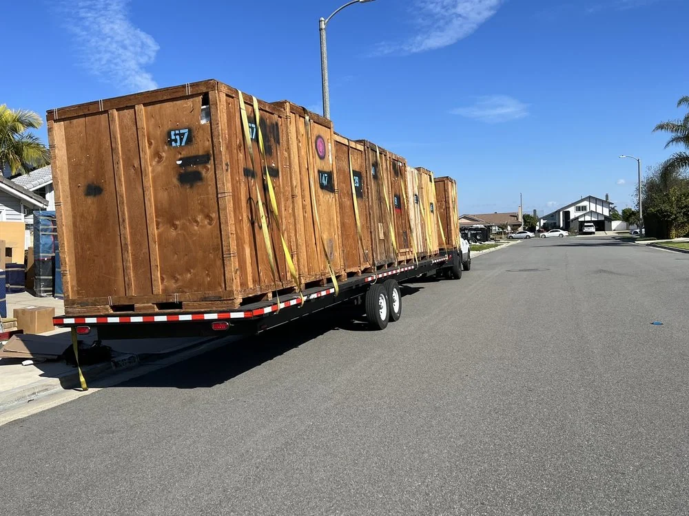 Movers preparing protected household items for loading