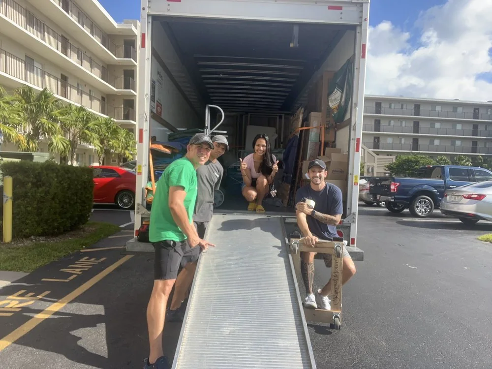 Movers preparing protected household items for loading